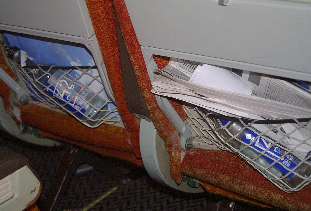 Empty bottles in seat pockets aboard Siberia Airlines Ilyushin Il-86 RA-86120